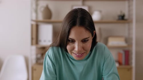 Young Woman Concerned While Using Laptop at Home