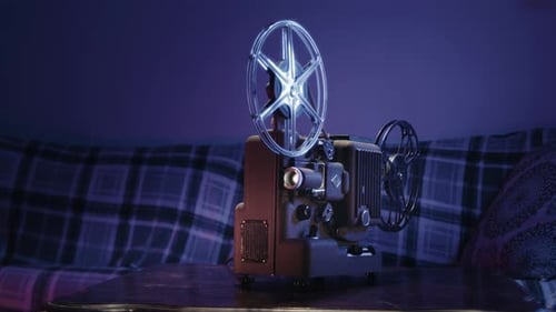 Vintage Film Projector Rotating in a Dim Room