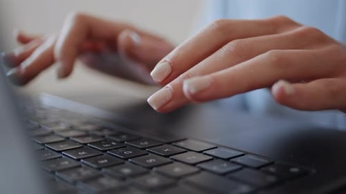 Woman Typing on Laptop Keyboard Close Up