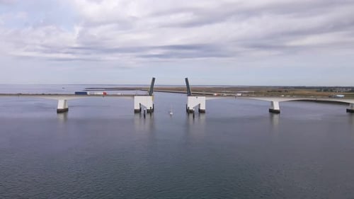 aerial footage of the open zeeland bridge in the netherlands on a cloudy day