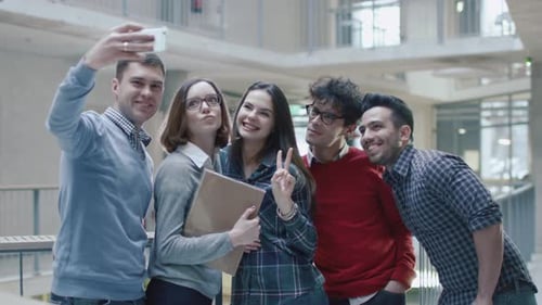 Group of young multi-ethnic students are making selfie pictures in an university.