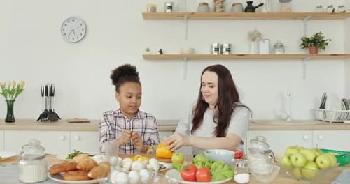 Happy Mother and Child Cooking Together in Kitchen