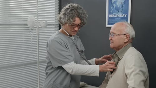 Female Nurse Checking Senior Patients Heart and Lungs