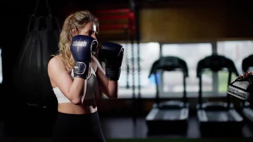 Woman Boxing with Trainer in Gym for Fitness