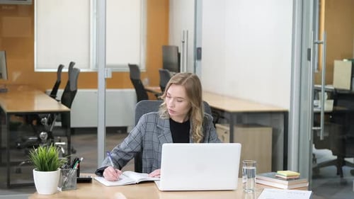 Businesswoman Working at Office Desk