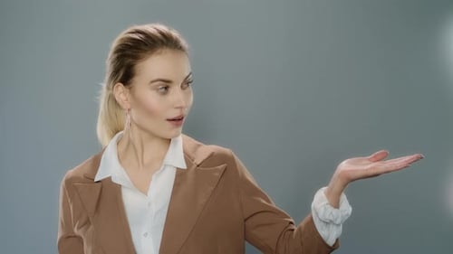 Smiling Woman Presenting Product with Hand Gesture
