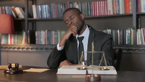 Brainstorming African American Lawyer Sitting in Office