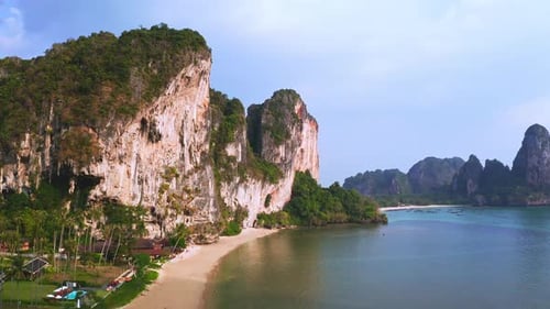 Steep rock cliffs above tropical Tonsai and Railay sea beach, Thailand.
