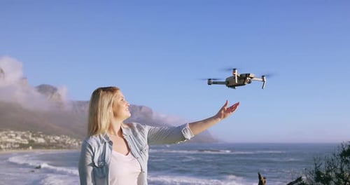 4k-Videomaterial eines jungen Mannes, der am Strand eine Drohne fliegt