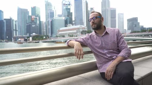 Young Man Relaxing on Bench in City 30s