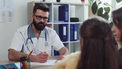 Doctor Consults with Child and Mother at Desk