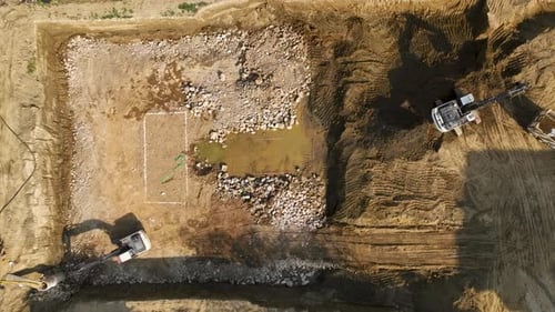 Early Stage Construction Aerial of Soil Removal By Excavators and Trucks