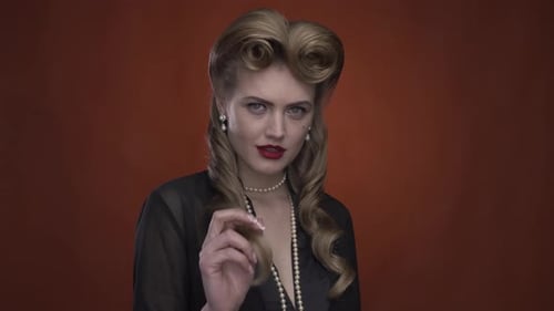 Blonde Woman With Vintage Hair Poses With Pearls