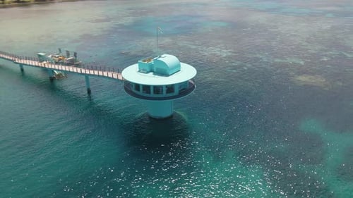 Drone orbiting around the Fish Eye Underwater Observatory in Guam USA