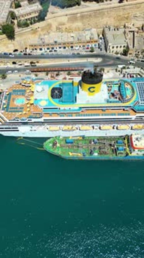 Aerial drone view of a cruise ship on the Mediterranean sea, near the walled city of Valletta, Malta
