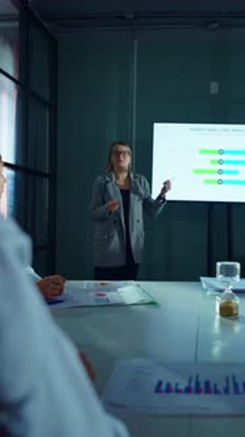 Businesswoman Presents Profit and Loss Analysis to Colleagues