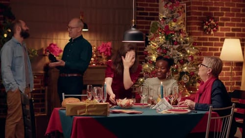 Adults Celebrating Christmas with Food and Decorations