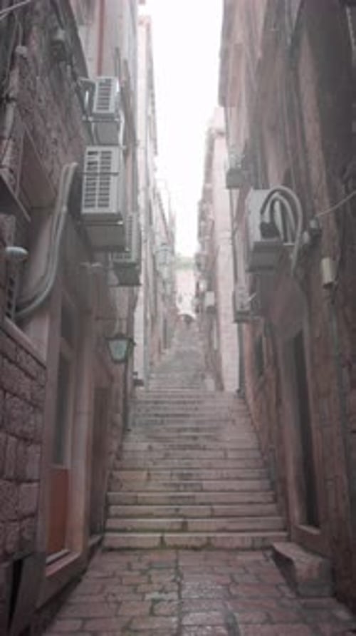 Quiet Ascent Along Worn Historic Steps Traveling Softly Upward on Aged and Weathered Stone Staircase