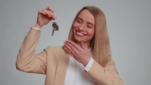 Businesswoman Real Estate Agent Showing the Keys of New Home House Apartment Renting Buying Property