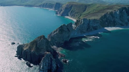 Aerial Panoramic View of Cliffs and Huge Rocks at Seaside and Waves Crashing to the Coast Beautiful