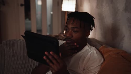 Man using Tablet at Home Late at Night