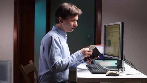 Office Worker Counting Last Money in Wallet at Night
