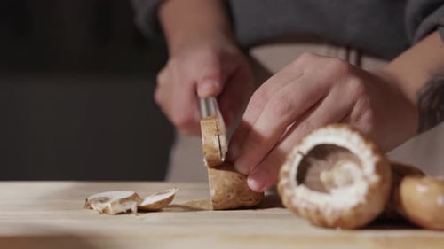 Female Hands Cutting Mushrooms Using A Knife - Close Up