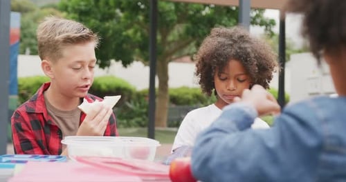 Children Enjoying Lunch Together Outside at School