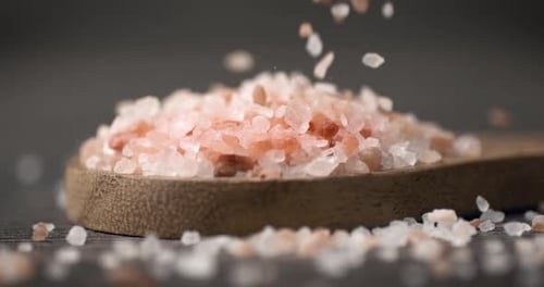 Pink Salt Falling onto Spoon in Close Up