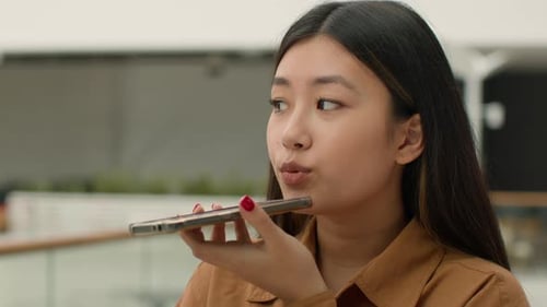 Young Woman Using Voice Command on Smartphone