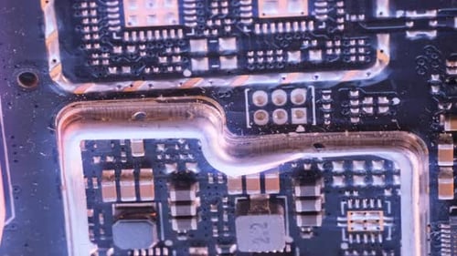 Microchips background tracking shot extreme macros close-up, purple colors. Circuit board surface.