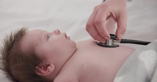 Baby, stethoscope and doctor listening to heart, breathing and test kids healthcare in clinic
