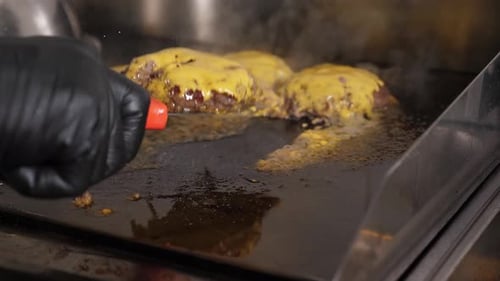 Cheeseburgers Cooking on Flat Top Grill