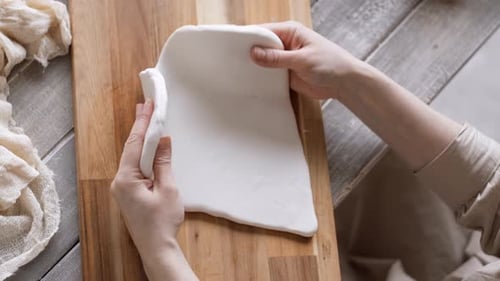 Person Prepares Dough on a Wooden Board