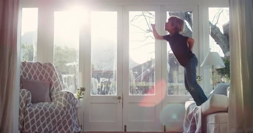 Boy Jumps From Couch and Pretends to Fly