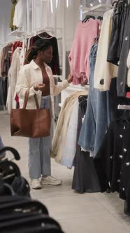 Vertical of Black Lady Shopping in Clothing Store