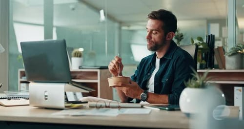 Eating, office and happy man with lunch, break and technology for finance, bookkeeping or report