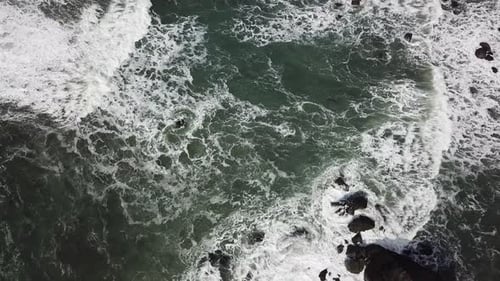 Rocky Coast With Rough Seas Aerial Flyover