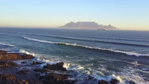 Aerial view of sunset on Cape Town beach with table mountain in the background