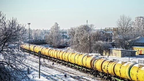 Fast clip of train on railroad passing by in the snow