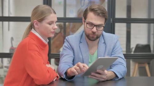 Business People Working on Tablet in Office