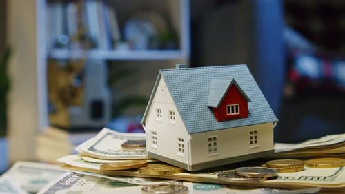 Build Wealth Through Property House Model On Dollar Background