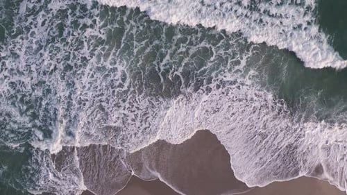 Aerial Top Down View on a Sandy Beach with Sea Surf Slow Motion Nobody
