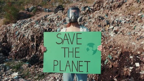 Young Adult Protests Pollution Wearing Gas Mask