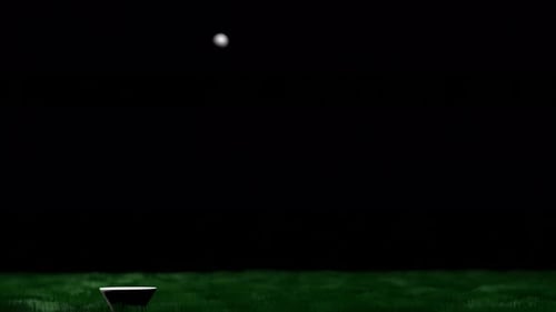 Golf club hits the ball.
