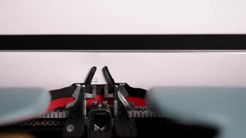 Closeup of Vintage Typewriter Mechanism Printing the Words THE END on Paper Moving Metal Parts and