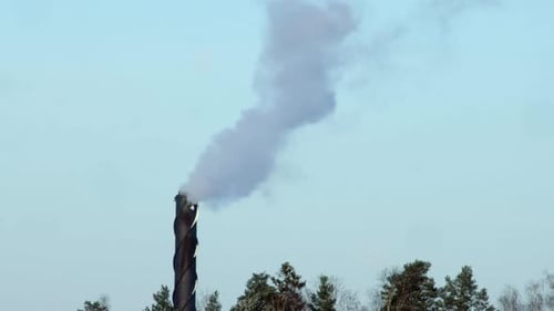 Smokestack Emitting Smoke Against Blue Sky