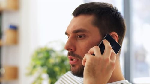 Man Talking on Mobile Phone Indoors