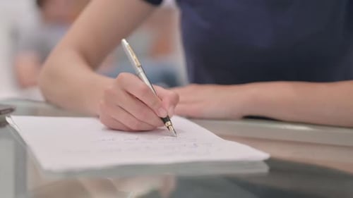 Close Up of Latina Woman Hand Writing on Paper