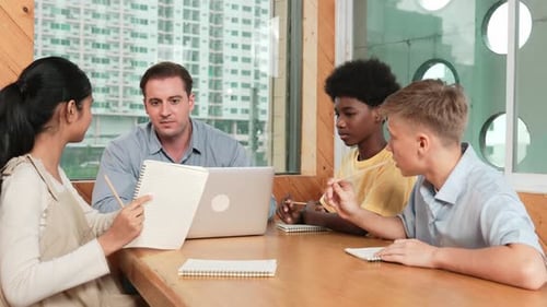 Diverse Group Meeting with Laptop in an Office